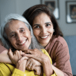Adult daughter helping elderly mother with hearing aids – family guide to hearing aids for seniors in India